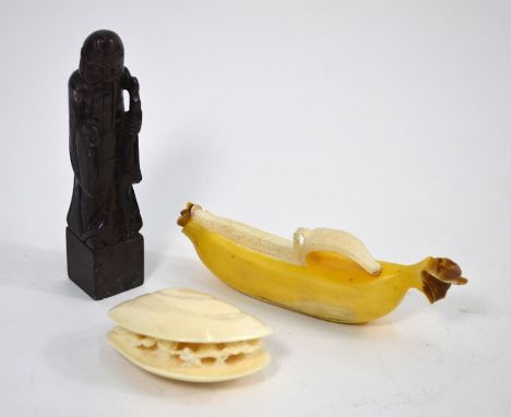 A small Japanese ivory okimono of a peeled banana, 10.5 cm long, Meiji Period; a small ivory okimono or netsuke, carved as fi