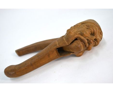 A 19th century Black Forest carved wood nutcracker, worked as a man's head in wool hat