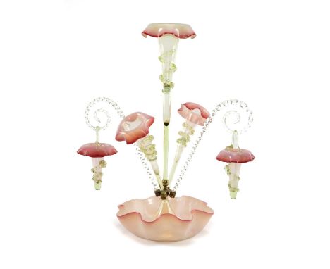 VICTORIAN GLASS EPERGNE, the handkerchief base supporting two twisted canes with baskets, and three trumpets, in pale green g