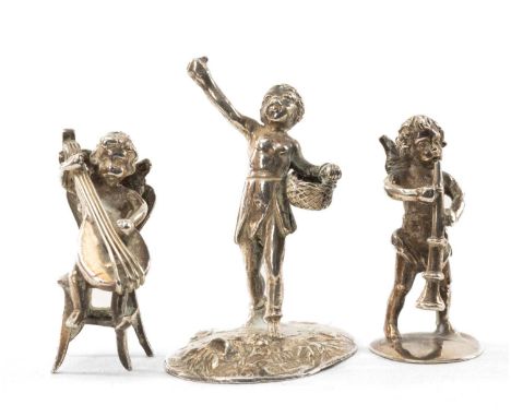 THREE CONTINENTAL SILVER FIGURINES, comprising child with basket, seated cupid with cello, and cupid with clarinet, all with 