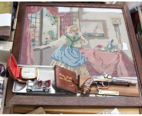 A woolwork glazed fire screen, a further woolwork, painted firescreen and bag, containing flintlock cigarette lighter, plated