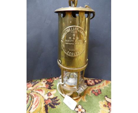 A late 19th/early 20th Century brass miners lamp, stamped projector lamp and lighting Eccles, 24 cm high approx 