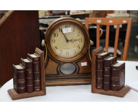 A rhythm mantel clock, with a Westmister chime, quartz movement, together with a pair of book ends, each in the form of gradu