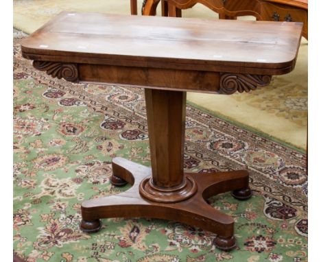 An early Victorian mahogany folding card table raised on an octagonal pedestal column and a platform base 