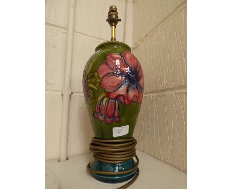 A Moorcroft lamp base, green ground, with Hibiscus pattern, measuring approx 33 cm high (plus lamp shade holder) 