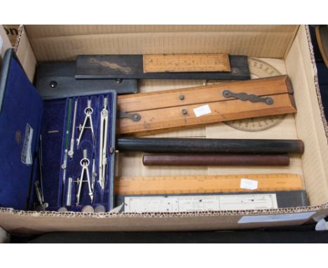 A box of draughtsman's instruments, including rulers, cased compass etc