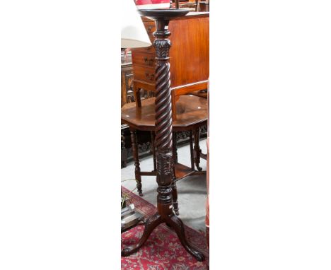 A George III style mahogany torchere, raised on a tripod base