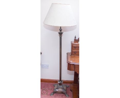 A contemporary brass standard lamp