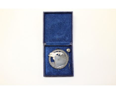 A World War Two German navy blockade breakers badge, cased with mini stick pin, maker marked 'Schwerin-Berlin'