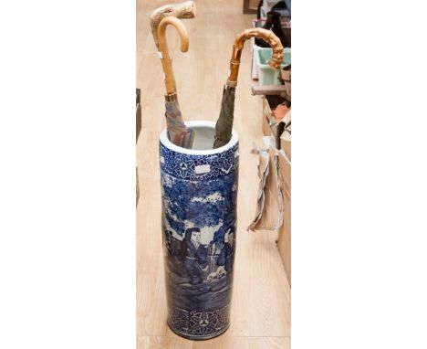 An oriental blue and white stick stand together with various umbrella stand walking stick