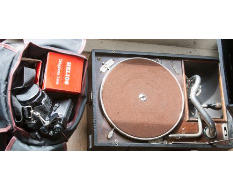 A cased Zenit camera, lense and flash, with a portable H.M.V record player (including wind up handle) (2) 