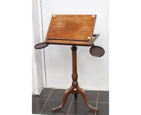 A George III mahogany adjustable tripod lectern, circa 1770 fitted with two candle holders, raised on turned column and stand