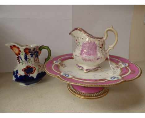 A hand painted dessert dish, raised on a single column, pink on white ground, with gilding and spring and bow decoration, pos
