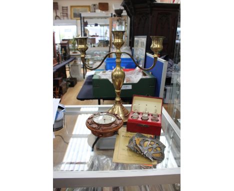 A three light, two branch brass candelabrum together with three AA badges, an apocetharies box with various glass tabloids bo