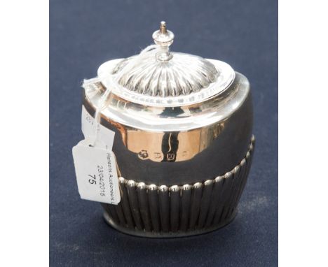 A Victorian oval semi-fluted silver tea caddy with lid, having urn shape finial, London 1897, A and J. Zimmerman 