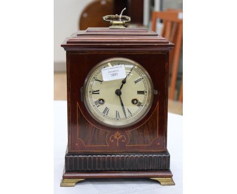 An Edwardian mahogany and inlaid bracket clock, printed dial with Roman numerals, brass handle and brass ogee bracket feet 