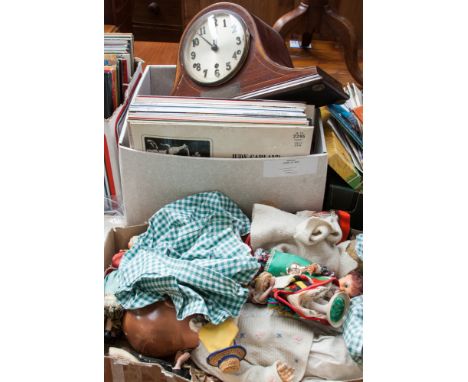 Two boxes of assorted items including a dome top mantel clock, records, dolls, etc