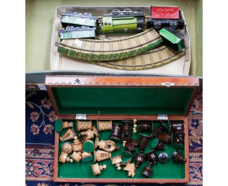 An Eastern European boxed carved wooden chess set. Together with a Chad Valley printed Tin Plate. British Railways train set 