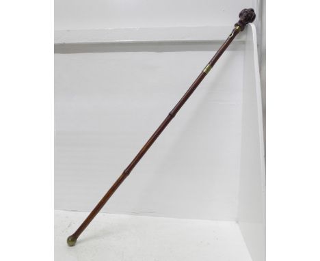 A c.1900 sword stick, with carved horn character handle and cane scabbard, blade 45.5cm 