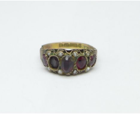 A Victorian 9ct gold ring set with red stones and seed pearls, Birmingham 1892, Solomon Henry Schwersee, 2g, shank a/f, one o