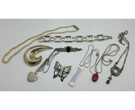 Three silver brooches, a silver bracelet, three pendants and chains, a necklace lacking fastener and a faux pearl necklace wi