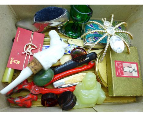 A compact, pen knives, a jade Buddah, etc. 