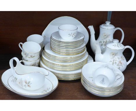 A Royal Doulton Yorkshire Rose tea set and dinner service, six setting with tea and coffee pot (one saucer missing) 