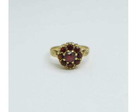 A 9ct gold and garnet cluster ring, 2.4g, K 