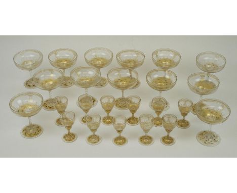 CHAMPAGNE GLASSES, a set of thirteen, Bohemian gilt enamel decorated, with eleven matching liquor glasses. (24) (with faults)