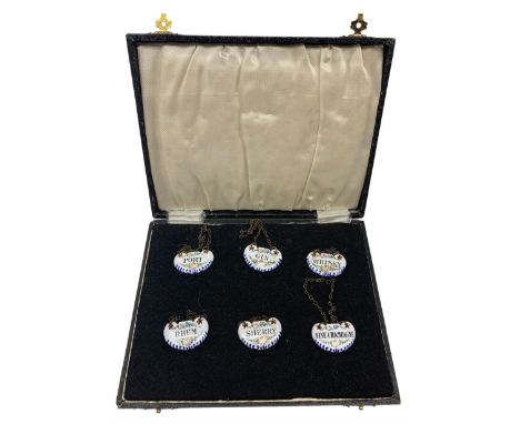 Set of six early 20th century French enamel decanter labels for Gin, Port, Whisky, Rhum, Sherry and Fine Champagne, each hand