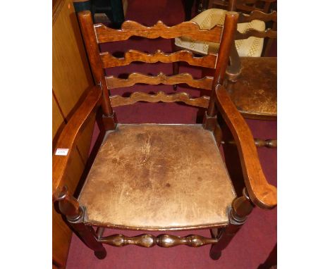 A set of twelve beech ladder back dining chairs, having fixed tan pad seats (6+6)