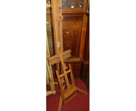 A modern beech freestanding adjustable artists easel; together with a similar table-top easel (2)