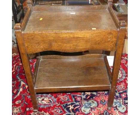 A 1930s oak two-tier tea trolley on roller castors, width 61cmCondition report: Dimensions 75 x 61 x 41cm.Quite wobbly and sc