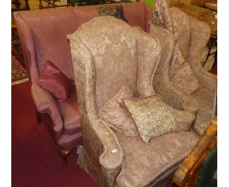 An early 20th century wingback three-seater sofa, together with a pair of early 20th century and later pink floral upholstere