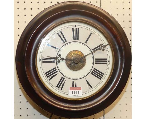 A 19th century stained mahogany circular postman's alarm clock, having twin weight driven movement, two weights and a pendulu