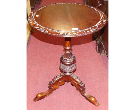 A contemporary hardwood circular fixed topped pedestal tripod occasional table, with floral carved detail, dia.50cm 