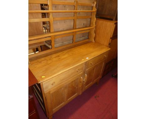 An Ercol style blond elm dresser, having two-tier open plate rack, width 130cm