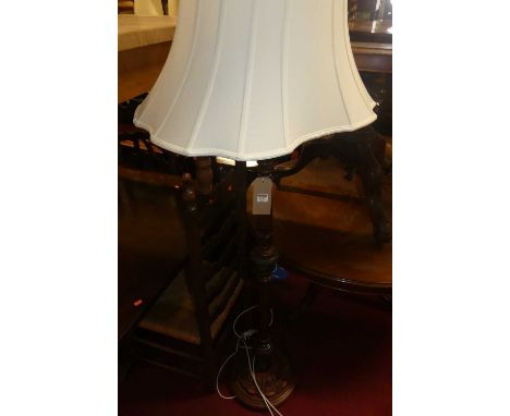 A mahogany stained and floral carved beech standard lamp
