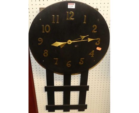 A stained oak circular wall clock, with applied brass hands and numerals, having openwork slatted trunk, h.79cm