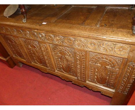 A circa 1700 joined oak four panel coffer, on original loop hinges and having candle-box fitted interior, the whole with rose