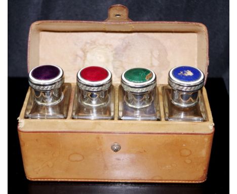 Boxed set 4 leather cased glass perfume bottles with enamel tops and glass stoppers (height approx 11cm), enamel as inspected