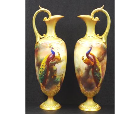Pair of Royal Worcester Hadley handpainted ewers signed W. White, with handpainted peacock scene decoration and ornate gilt h