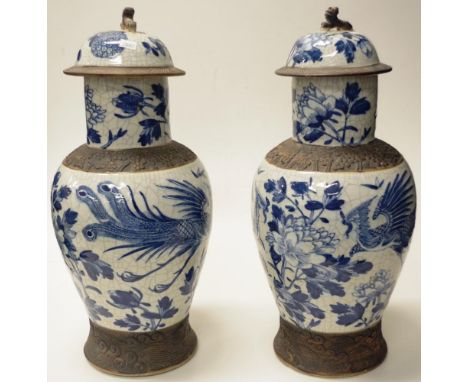 Pair Antique Chinese large lidded ceramic vases each with blue and white bird and blossom decoration on crackle glaze, charac