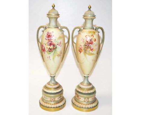 Pair of Royal Worcester blush ivory lidded urns Circa 1898, with ornate floral spray and gilt decoration, ornate twin handles