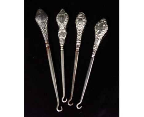 Four antique silver handle buttonhooks each button hook with embossed decoration to sterling silver handle, (length 16cm appr