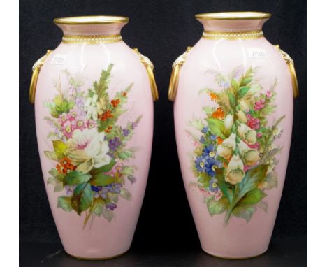 Pair of Royal Worcester hand painted vases with floral spray decoration on pink ground, ornate gilt attached handles and gilt
