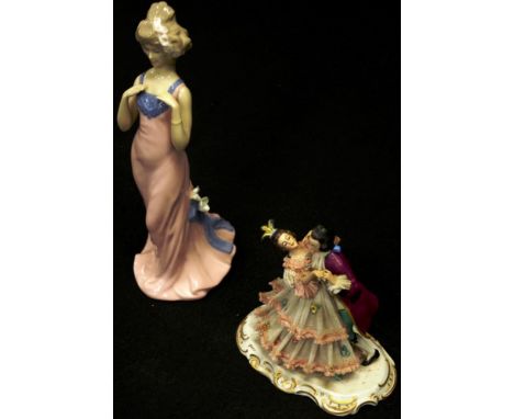 Dresden lace dancing couple figure marked to base, (height 16cm approx); together with a Spanish ceramic standing woman figur