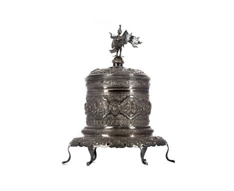EARLY 20TH CENTURY BURMESE SILVER TEA CADDY ON STAND,the cover with finial in the form of a deity, with additional interior c