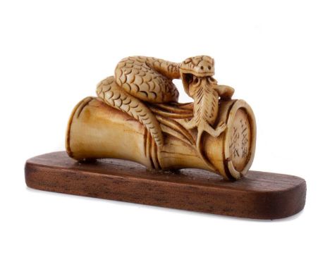 JAPANESE IVORY NETSUKE,late Meiji/early Taisho Period, carved as a snake devouring a mouse upon a section of bamboo, signed, 