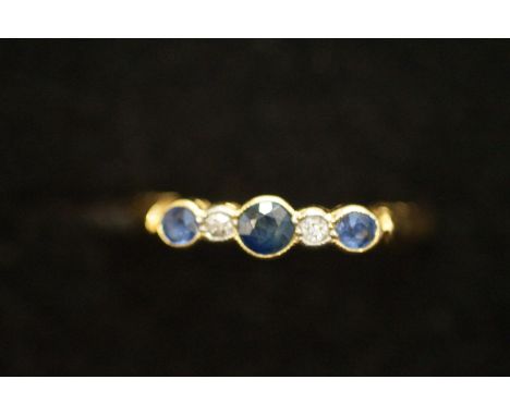 18ct gold ring set with 3 good quality and coloured sapphires and 2 diamonds, size- O